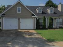 Charming single-Gathering home features a two-car garage, well-maintained lawn, and neutral siding at 3020 Meadow Glen Pass, Fairburn, GA 30213