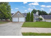 Charming single-Gathering home with a well-manicured lawn, two-car garage, and inviting curb appeal at 3020 Meadow Glen Pass, Fairburn, GA 30213