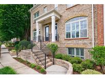 Charming brick townhouse with well-maintained landscaping and inviting front entrance at 359 Alderwood Ln, Atlanta, GA 30328