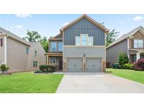 Charming two-story home with a two-car garage and well-maintained lawn in a suburban neighborhood at 4630 Roseman Trl, Cumming, GA 30040