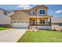 Charming two-story home with a welcoming front porch and a well-manicured lawn at 9183 Golfview Cir, Covington, GA 30014