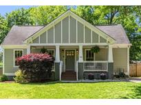 Charming craftsman-style home with well-manicured lawn and inviting front porch at 166 Martha Ave, Atlanta, GA 30317