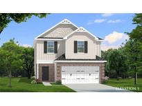 Charming two-story home featuring brick facade, attached two-car garage, and manicured lawn at 82 Hydrangea Cir, Fairburn, GA 30213