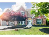 Charming two-story brick home featuring a manicured front yard, mature landscaping, and inviting curb appeal at 6505 Hampton Creek Dr, Cumming, GA 30041