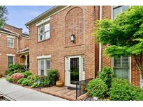 Charming brick home featuring manicured landscaping and a welcoming entrance at 505 Ansley Villa Dr, Atlanta, GA 30324