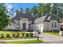 Beautiful brick home featuring an attached garage, manicured lawn, and carefully designed landscaping at 4216 Tattnall Run, Acworth, GA 30101