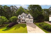 Charming two-story home with lush landscaping and a well-manicured lawn at 5015 Preservation Pointe Nw, Kennesaw, GA 30152