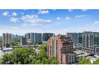 Expansive city view with high rise apartments and neighborhood trees during daytime blue sky at 3180 Mathieson Ne Dr # 1001, Atlanta, GA 30305