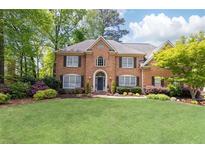 Charming brick home with a manicured lawn and mature trees, offering great curb appeal at 93 Ridgetree Ln, Marietta, GA 30068