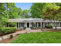 Charming brick home with black shutters and a lush green lawn, creating a welcoming curb appeal at 1130 Angelo Ne Ct, Atlanta, GA 30319