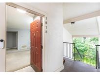 Inviting entryway featuring unit number, doorbell, and view into the main living space at 1818 Huntingdon Chase, Atlanta, GA 30350
