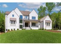 Stunning white brick home with a lush green lawn and manicured landscaping at 541 Londonberry Rd, Atlanta, GA 30327