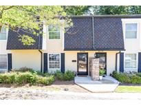 Charming townhome exterior with well-maintained landscaping and visible unit numbers above the doors at 6109 Park Ave, Atlanta, GA 30342