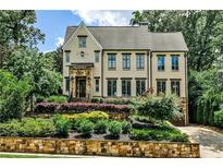 Inviting two-story home with manicured landscaping and stone accents on the front exterior at 171 Beverly Ne Rd, Atlanta, GA 30309