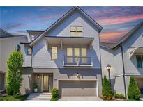 Charming two-story home with a balcony, attached garage and a well-manicured front yard at 4046 Hazel Nut Ln, Atlanta, GA 30342