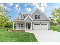 Charming exterior of a two-story home featuring a manicured lawn and welcoming curb appeal at 1482 Alcovy Station Rd, Covington, GA 30014