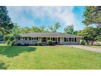 Charming single-story home featuring a well-maintained lawn and traditional brick facade with black shutters at 5327 David Cir, Covington, GA 30014