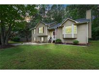 Charming split-level home with a well-manicured lawn and inviting front entrance at 685 Maplelake Dr, Acworth, GA 30101