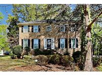 Traditional two-story brick home with black shutters and manicured landscaping at 2068 Signal Ridge Nw, Kennesaw, GA 30152