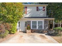 Charming two-story home featuring brick accents, neutral siding and red shutters at 3652 Platina Park Ct, Decatur, GA 30034