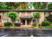 Charming brick townhome featuring a cozy entrance, stone accents and landscaped greenery, perfect for comfortable living at 120 Biscayne Nw Dr # C13, Atlanta, GA 30309
