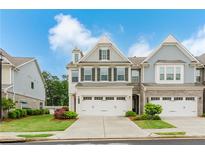 Charming two-story townhome with a well-manicured lawn and two-car garage for convenient parking at 2089 Lanier Harbor Pt # 2089, Buford, GA 30518