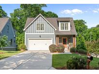 Charming home showcasing a well-maintained front yard and a two-car garage at 1810 Annie Nw St, Atlanta, GA 30318