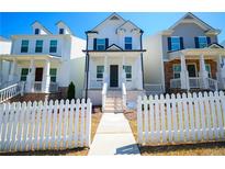 Charming two-story home with white picket fence and inviting front porch, perfect curb appeal at 458 Bishop Ln, Woodstock, GA 30188