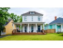 Charming white two-story home with a welcoming front porch and well-manicured lawn at 437 E Ontario Sw Ave, Atlanta, GA 30310