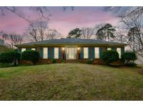 Charming brick home with blue shutters and manicured landscaping at 118 Heritage Way, Peachtree City, GA 30269