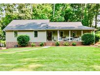 Charming single-story home with manicured lawn and inviting front porch at 3255 Sutcliffe Nw Rdg, Marietta, GA 30064