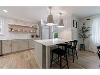 Bright kitchen with stainless steel appliances, center island with seating, and stylish pendant lighting at 2840 Alpine Rd, Atlanta, GA 30305