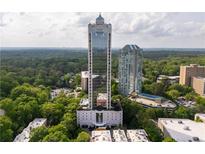 Stunning aerial view of a high-rise condo building surrounded by lush greenery and city skyline at 2828 Peachtree Nw Rd # 1501, Atlanta, GA 30305