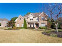 Charming two-story brick home with manicured lawn and inviting entrance at 440 Scott Farm Dr, Powder Springs, GA 30127