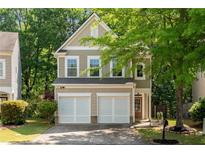 Charming two-story home with a well-manicured lawn and a two-car garage at 562 Poplar Bnd, Canton, GA 30114