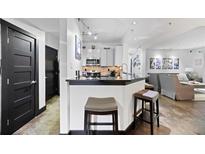 A charming kitchen featuring a breakfast bar, stainless steel appliances, and elegant modern finishes at 1250 Parkwood Se Cir # 3001, Atlanta, GA 30339