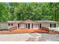 Charming one-story home with a large wooden deck, perfect for relaxing outdoors at 6670 George Ct, Cumming, GA 30041