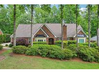 Charming brick home with lush landscaping and mature trees offering great curb appeal at 3456 Drayton Ne Dr, Roswell, GA 30075