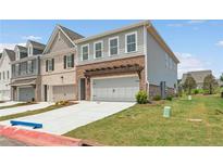 New construction home featuring brick, gray siding, a pergola, and an attached two-car garage at 4541 Moray Dr, Mableton, GA 30126