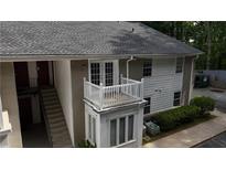 A multi-level apartment building featuring a charming white balcony, stairs, and a well-maintained exterior at 1212 Utoy Springs Rd # 46, Atlanta, GA 30331