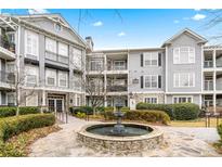 Attractive condo building with well-maintained landscaping and water fountain feature at 4100 Paces Se Walk # 2304, Atlanta, GA 30339