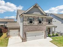 Two-story home featuring a two-car garage and an additional one-car garage at 66 Cottontail Ln, Loganville, GA 30052