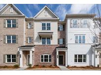 Charming townhomes featuring a mix of brick and siding, complemented by well-manicured landscaping at 4822 Floydwood Ln, Mableton, GA 30126