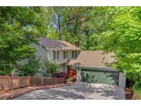 Charming home with a two car garage, wooden fence and ample yard space at 615 Nw Mark Trail Nw Ct, Atlanta, GA 30328