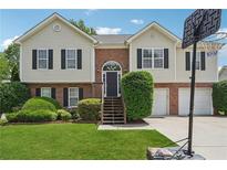 Charming two-story home with brick and siding, arched front door, manicured lawn, and a basketball hoop at 3123 Morgan Box Ln, Buford, GA 30519