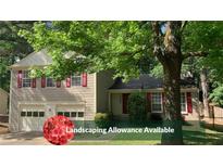 Charming two-story home with a two car garage, landscaped yard, and landscaping allowance available at 615 Barrington Way, Roswell, GA 30076