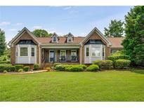 Charming brick home with manicured lawn and lush landscaping creating wonderful curb appeal at 5917 Southland Dr, Stone Mountain, GA 30087