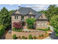 Beautiful brick home with manicured landscaping and a welcoming front entrance at 8745 Islesworth Ct, Duluth, GA 30097