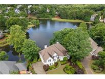 Stunning aerial view of lakefront home featuring lush landscaping and a private waterfront setting at 9115 Nesbit Lakes Dr, Alpharetta, GA 30022