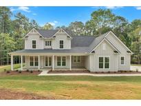 Charming two-story home featuring a covered front porch, landscaped yard, and classic architectural details at 12 Cedar Gate Ln, Kingston, GA 30145
